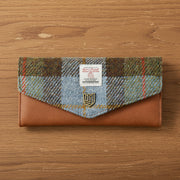 Chestnut and blue tartan Harris Tweed clasp purse on wooden surface