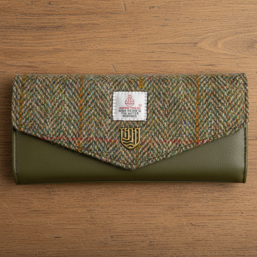 Chestnut herringbone Harris Tweed clasp purse with olive leather on wooden surface