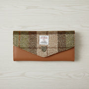 Chestnut tartan Harris Tweed clasp purse on light grey wood surface
