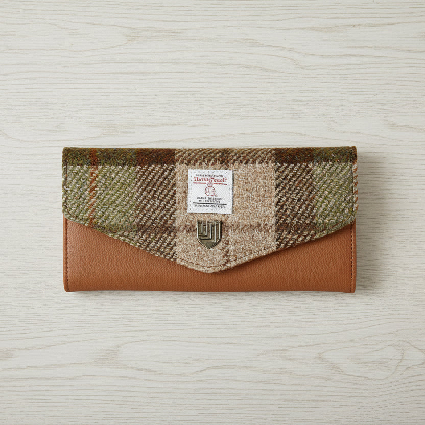 Chestnut tartan Harris Tweed clasp purse on light grey wood surface