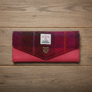 Fuchsia tartan Harris Tweed clasp purse with pink leather on wooden surface
