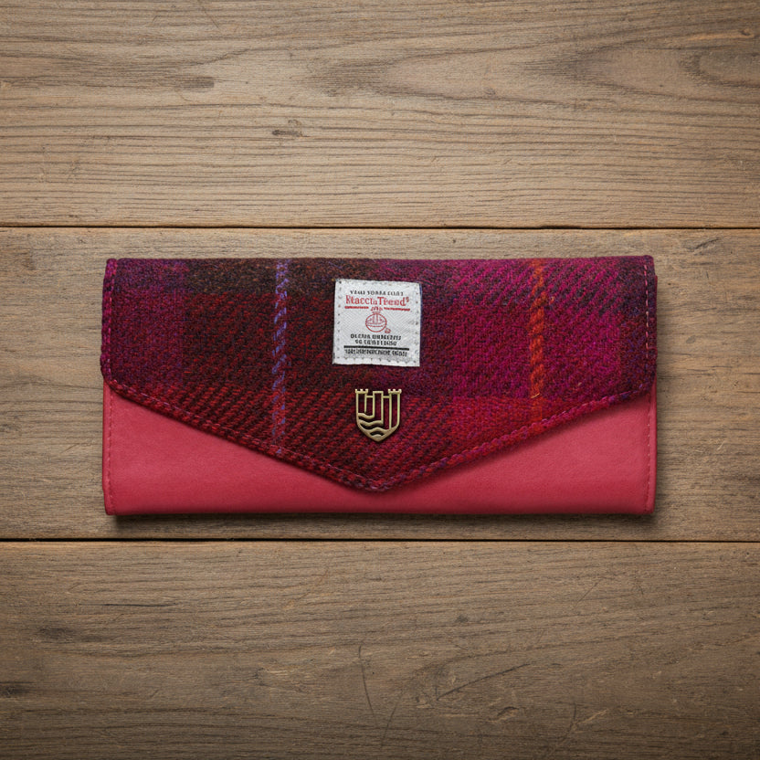 Fuchsia tartan Harris Tweed clasp purse with pink leather on wooden surface
