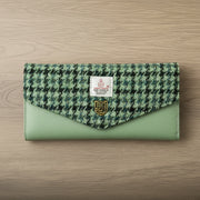 Green dogtooth Harris Tweed clasp purse with sage leather on light wood