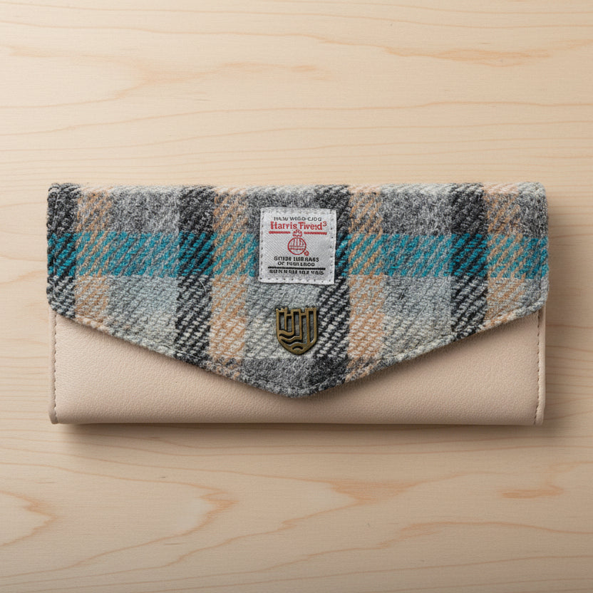 Islander tartan Harris Tweed clasp purse in grey blue and cream on light wood