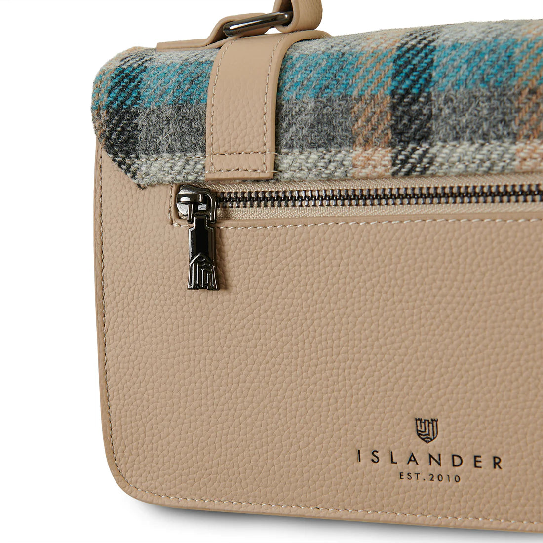 Detail of Islander tartan Harris Tweed satchel showing rear zip and leather texture.
