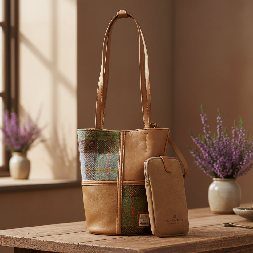 Orlagh chestnut-blue tartan Harris Tweed bucket bag in lifestyle setting with flowers