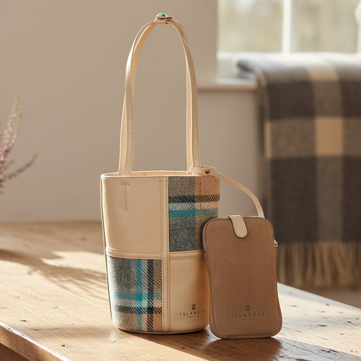 Orlagh bucket bag in cream check Harris Tweed on wooden table with phone pouch