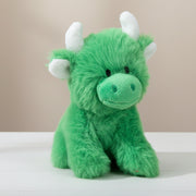 Mini green Highland cow soft toy with white horns on beige background