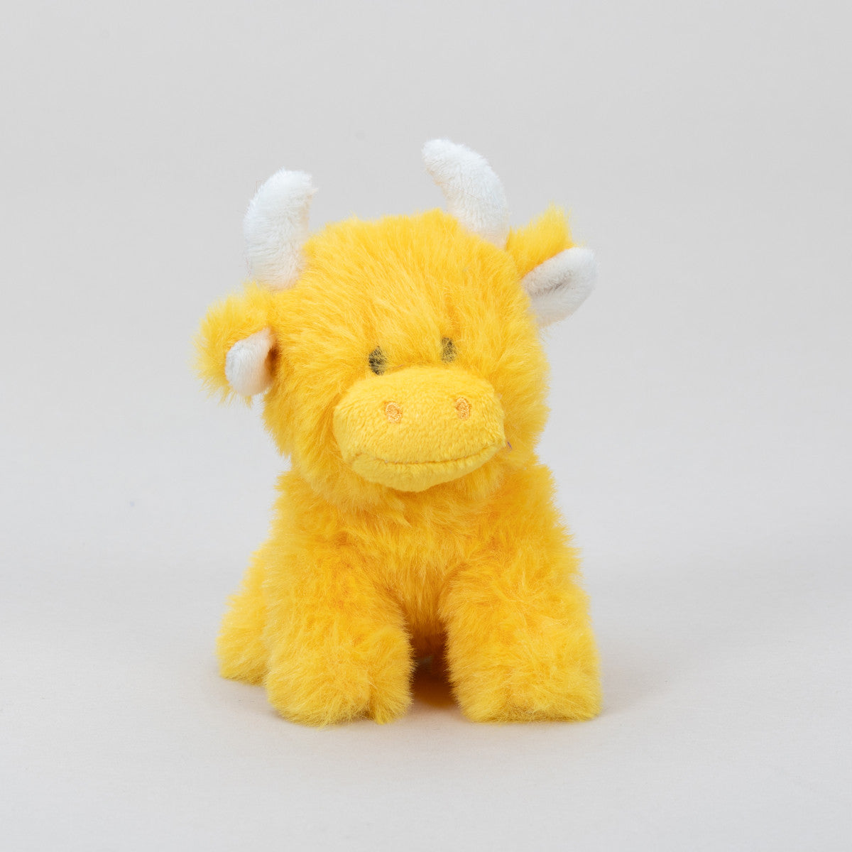 Orange Highland cow collectible plush front view on grey background
