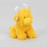 Mini orange Highland cow soft toy side view with white horns on grey background