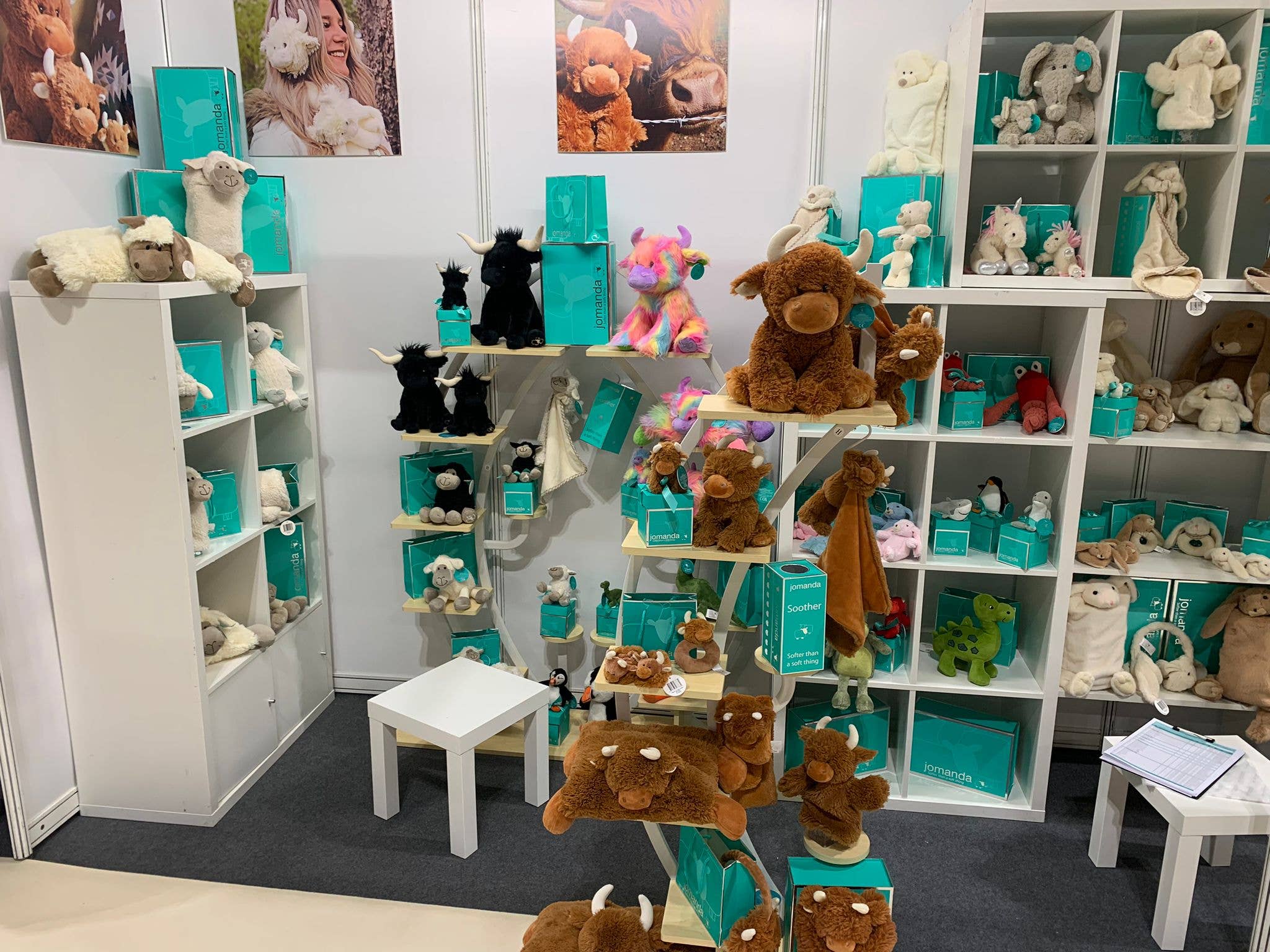 Jomanda plush toy stand with highland cows and rainbow plushies