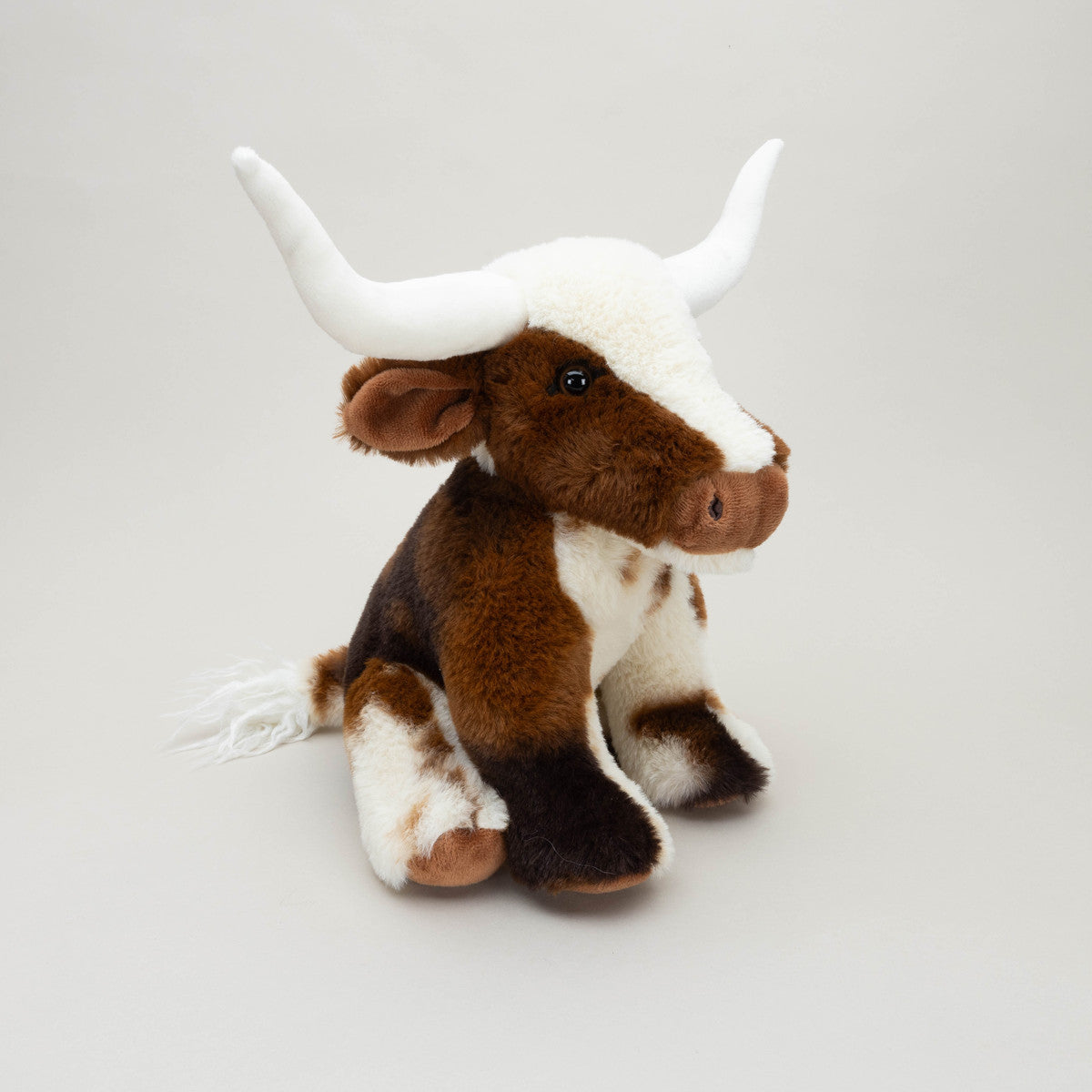 Brown and white Texas Longhorn plush toy front angled view on grey background