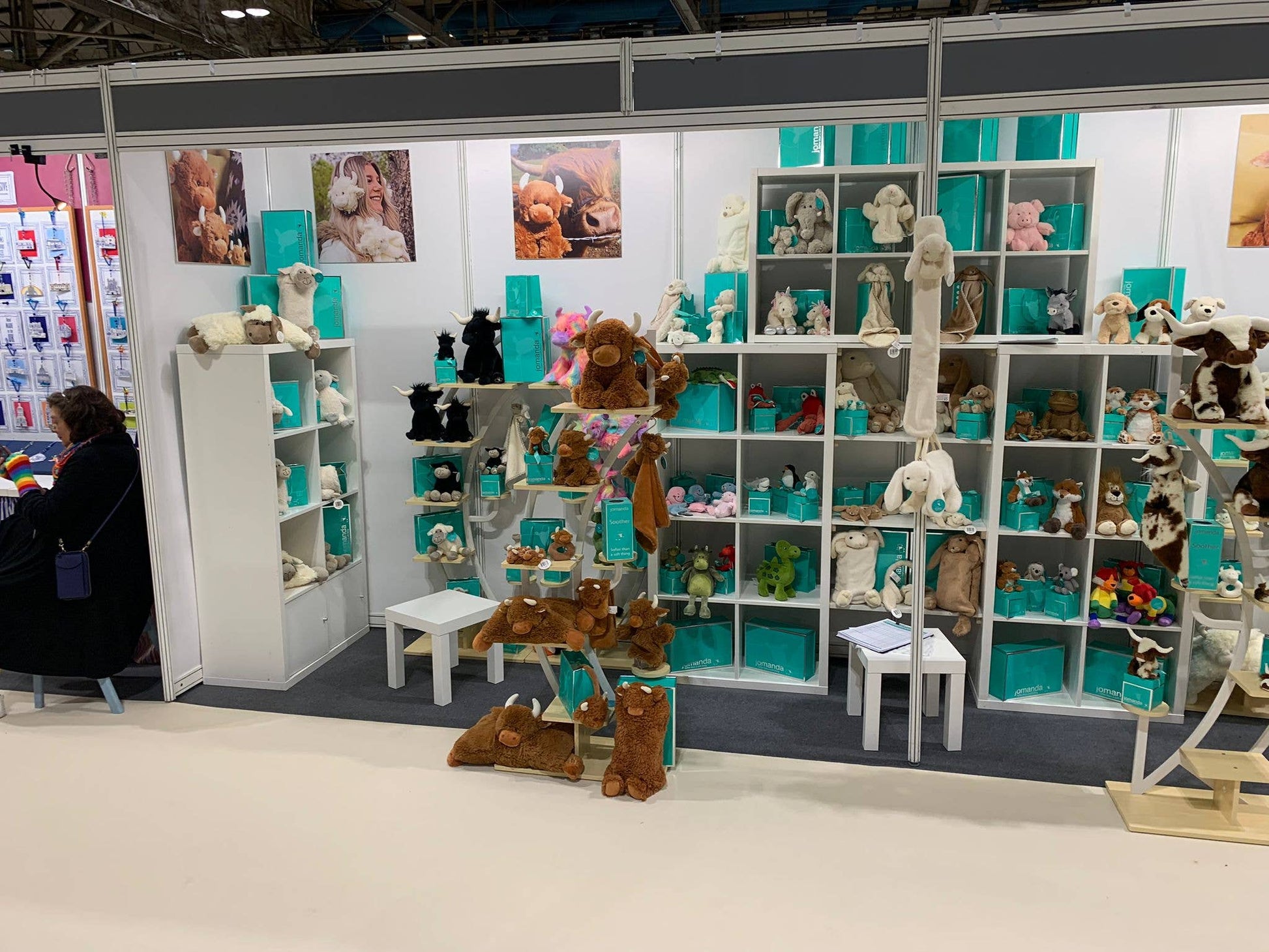 Jomanda trade stand overview with soft toy shelving and branded teal packaging