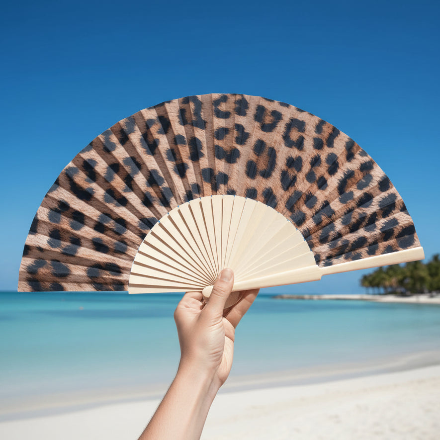 Leopard print fan held at beach location