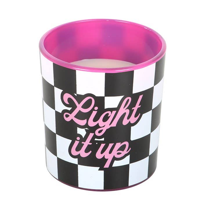 Checkerboard Light It Up Candle with pink interior glass and bold pink text, scented with strawberry and vanilla.