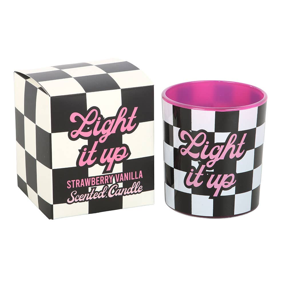 Light It Up Strawberry Vanilla Candle and matching packaging featuring pink typography and black-and-white checkerboard pattern.