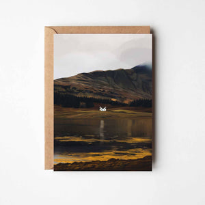 Illustrated Loch Eil greeting card featuring a white cottage by calm water with dramatic Scottish hills in the background.
