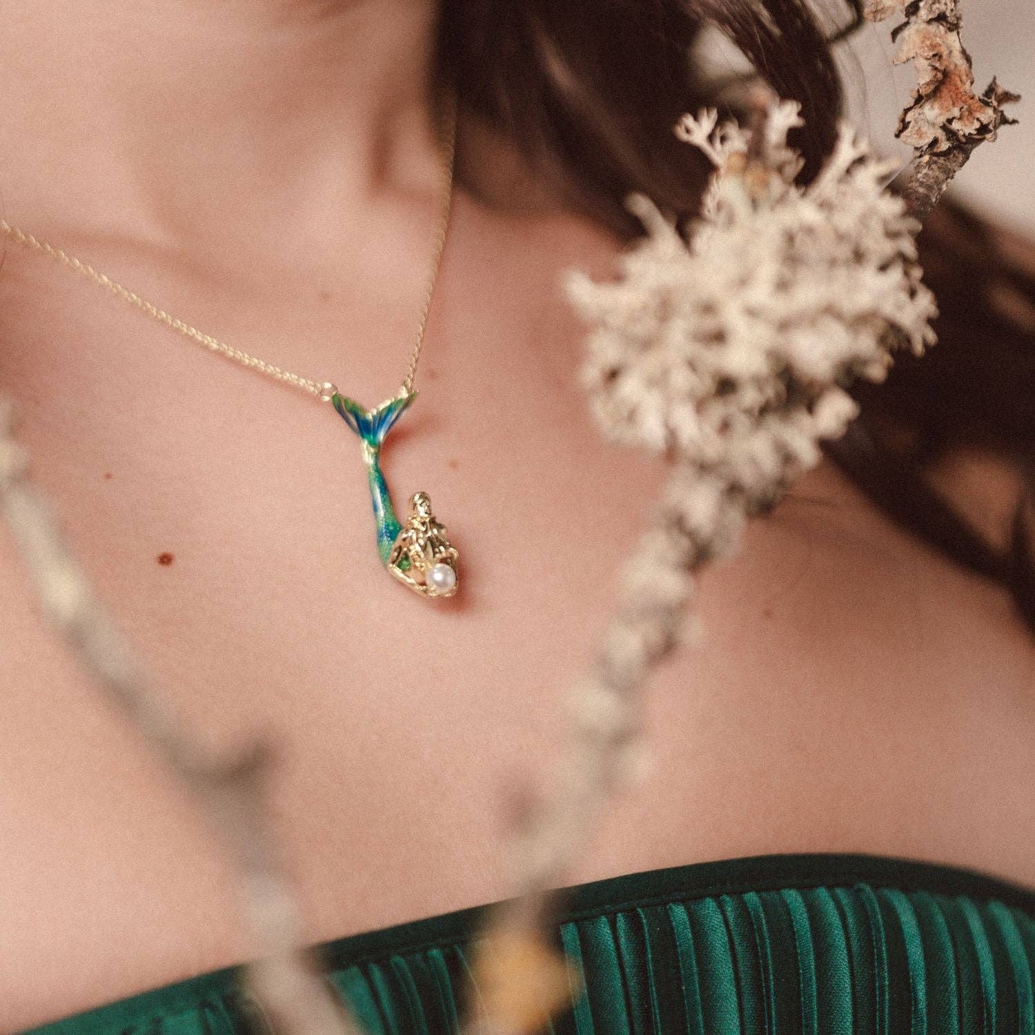 Model wearing Mermaid Pendant necklace with gold-plated mermaid and pearl charm.