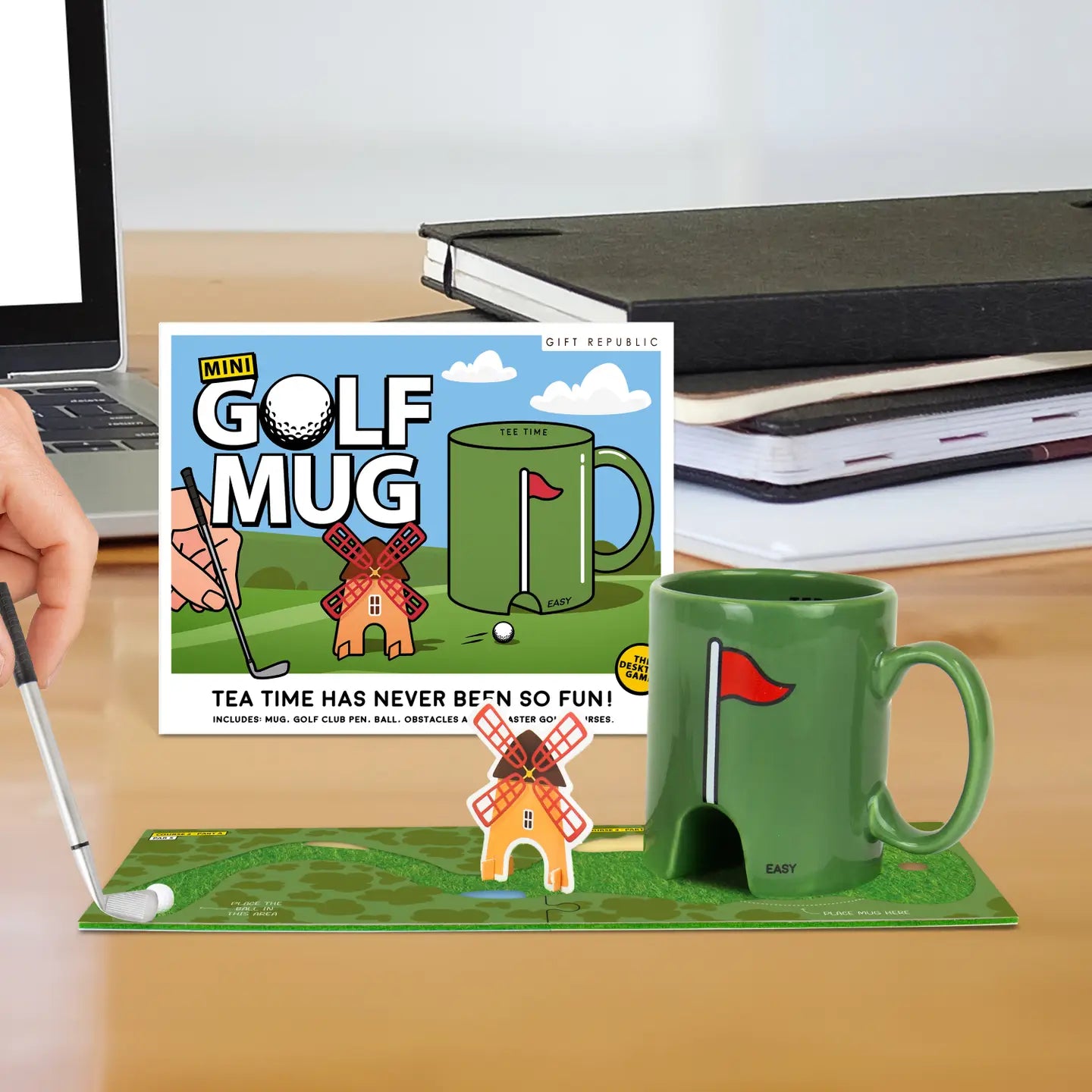Green mini golf mug with putting coaster game set on desk