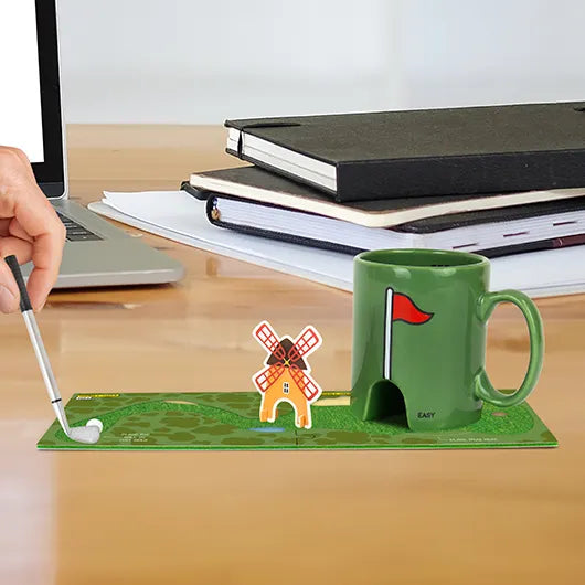 Mini golf coaster course set up with mug hole and golf club pen