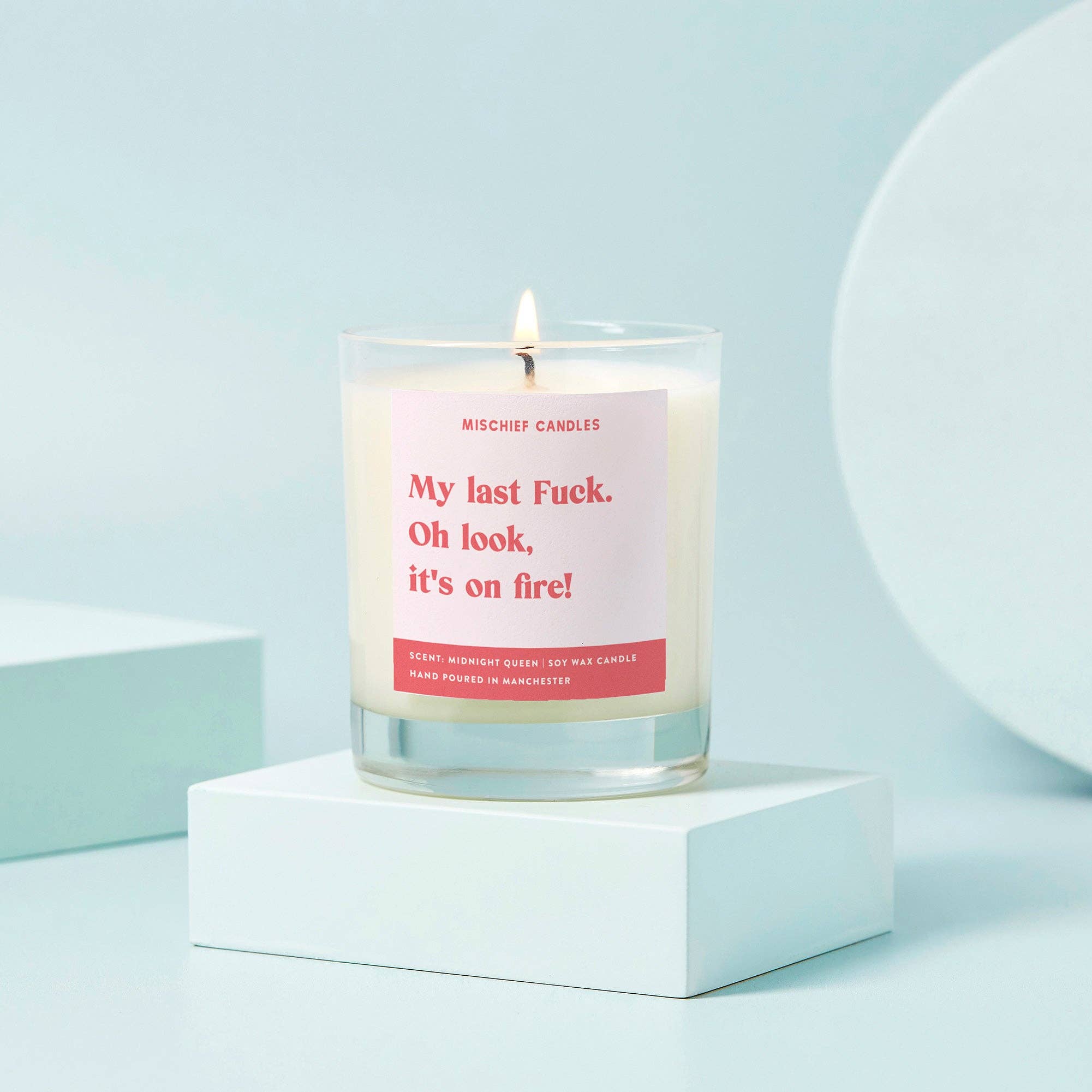 My Last Fuck funny candle in clear glass with Midnight Queen label on pale blue backdrop