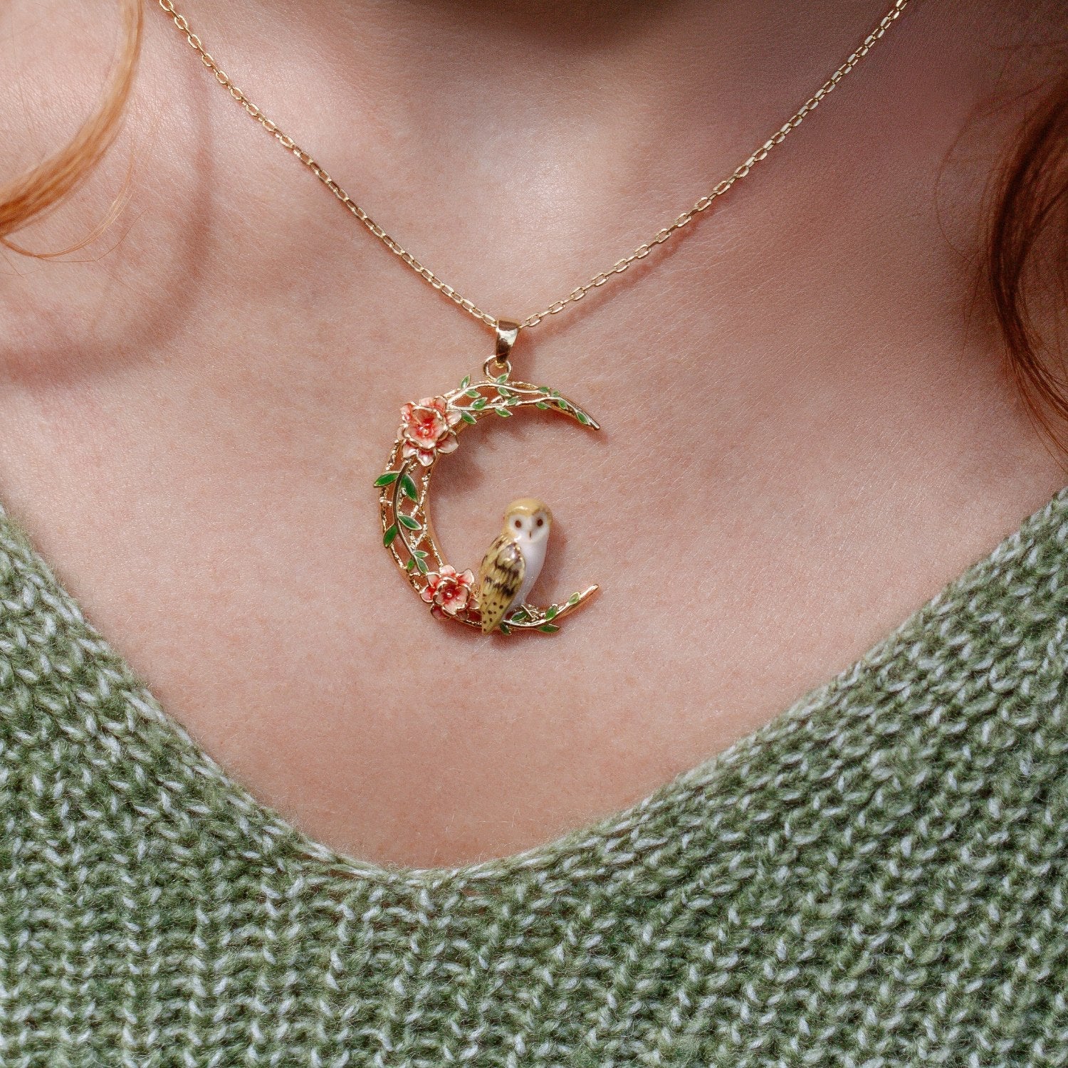 Model wearing Owl in a Moon Pendant showcasing gold crescent moon with owl and floral enamel detailing by Bill Skinner.