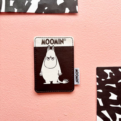 Front view of Angry Moomin Cardholder showing bold Moomin design on pink background with monochrome decor.
