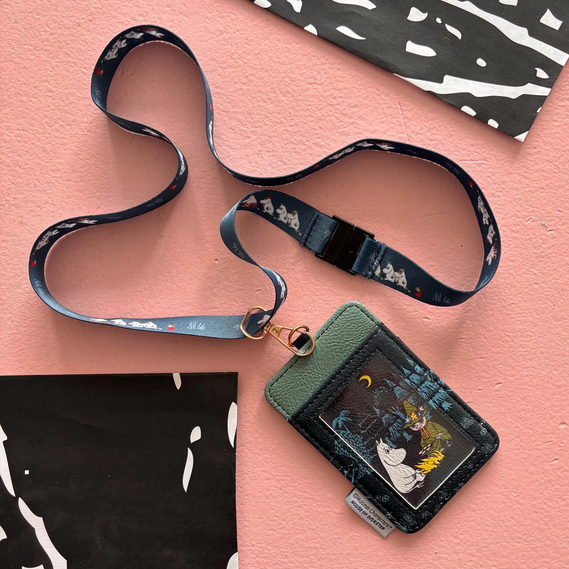 Rear flat lay of Moomin Forest Lanyard showing ID window and forest print design.
