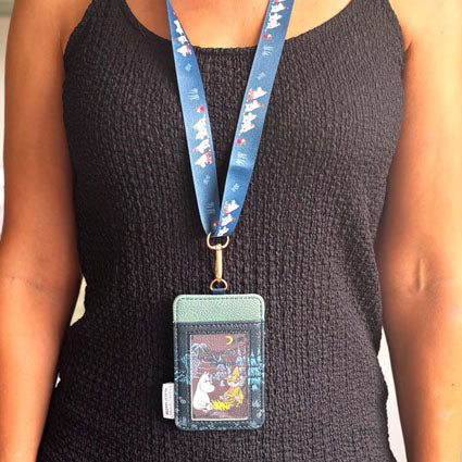 Model wearing Moomin Forest Lanyard with Moomin character design on dark green background.
