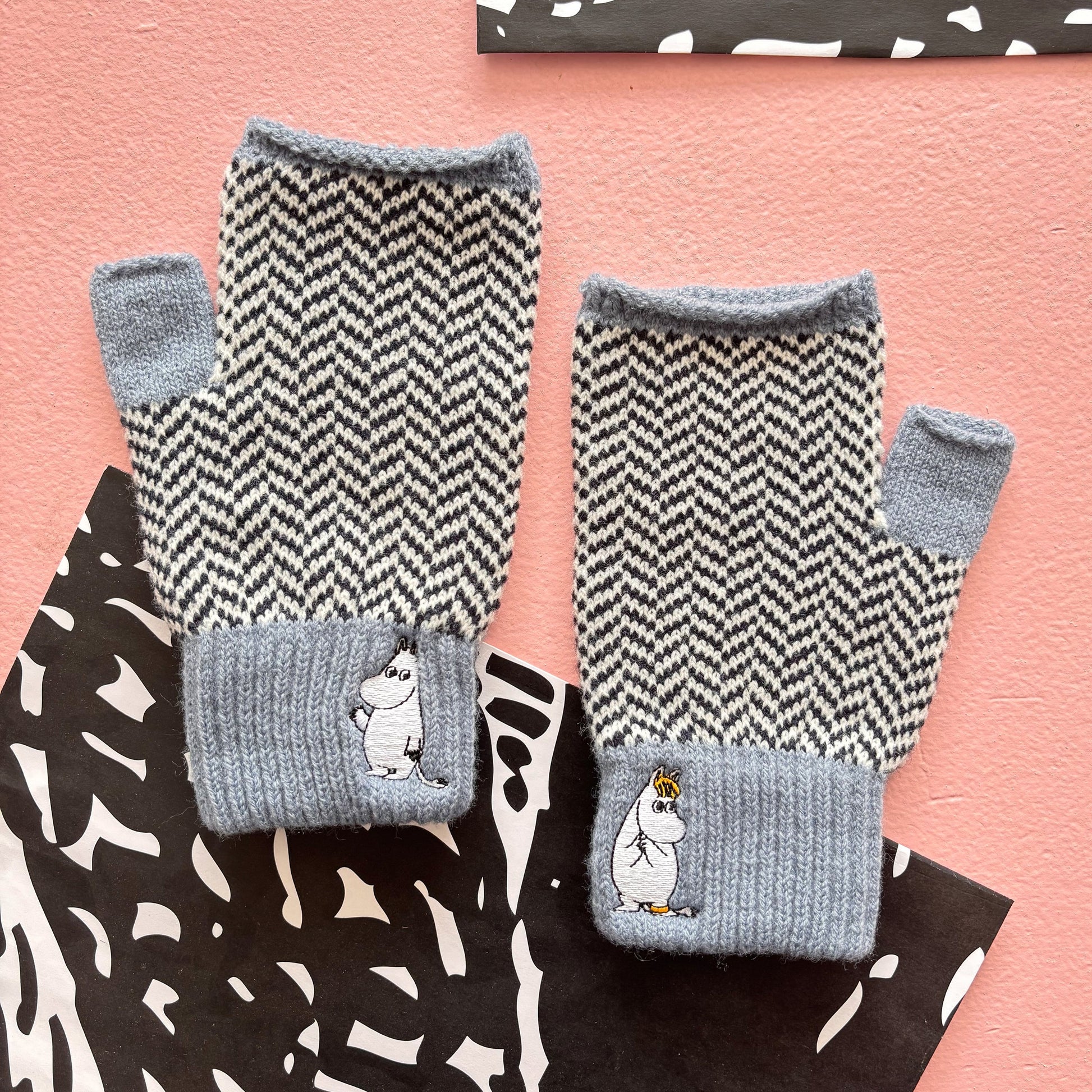 Pair of Moomin Herringbone Gloves laid flat showing front and back patterns with embroidered details.