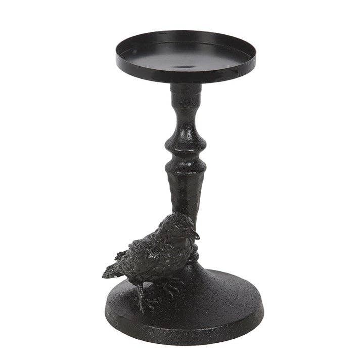 Black raven perched on gothic base candle holder