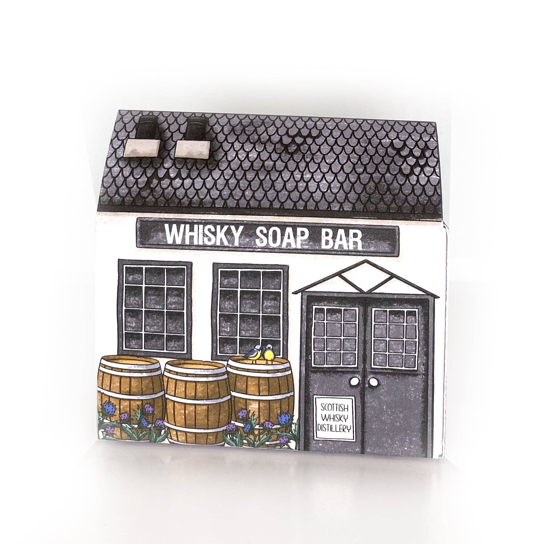 Neon Magpie Distillery soap packaging showing whimsical distillery illustration.
