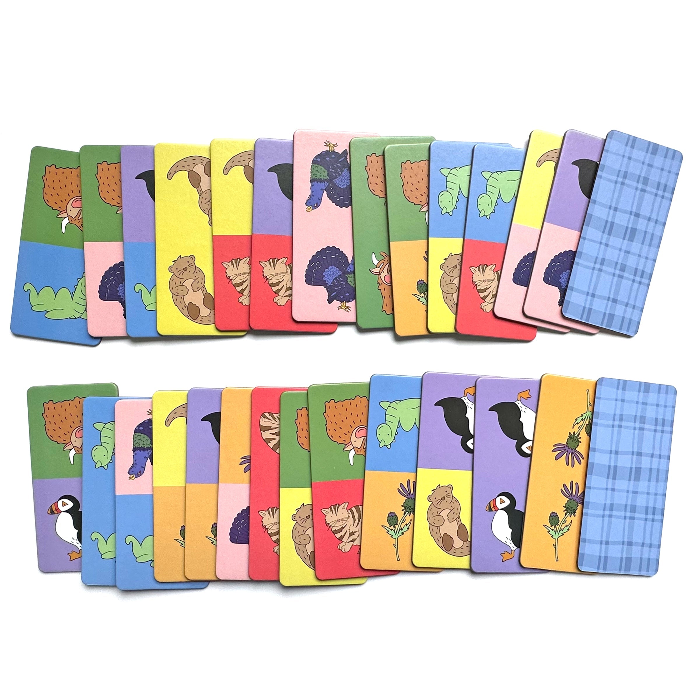 Scotland Dominoes tiles spread out showing Scottish animals and tartan backs on white
