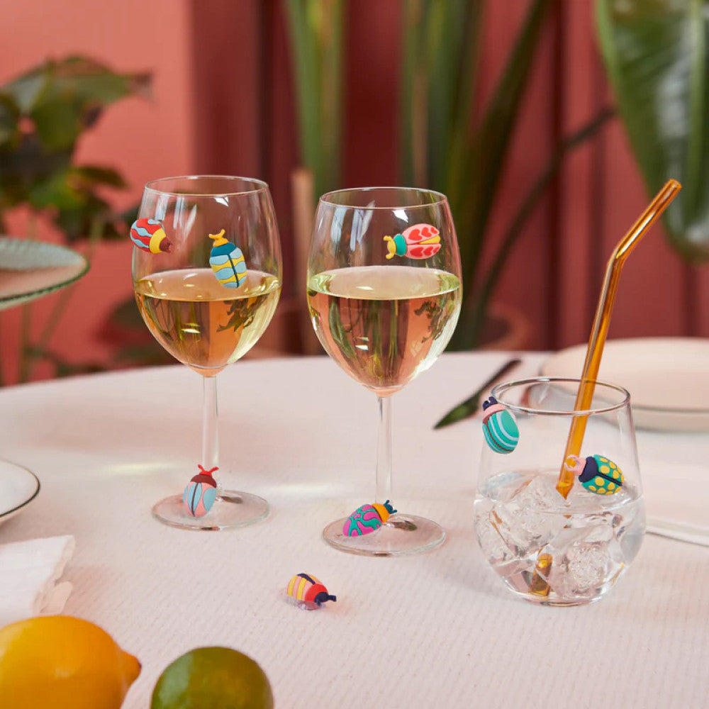 Wine glasses with beetle markers in colourful table setting
