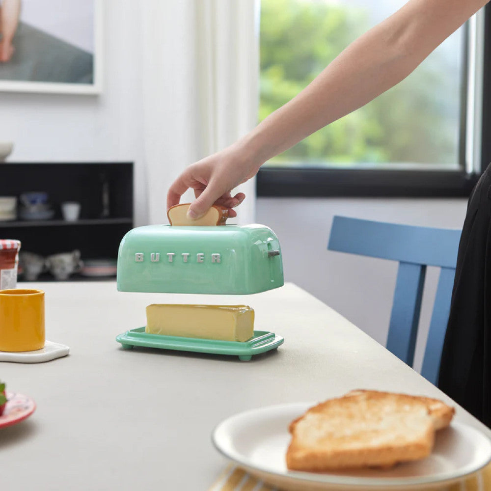 Turquoise toaster butter dish on kitchen counter with breakfast items