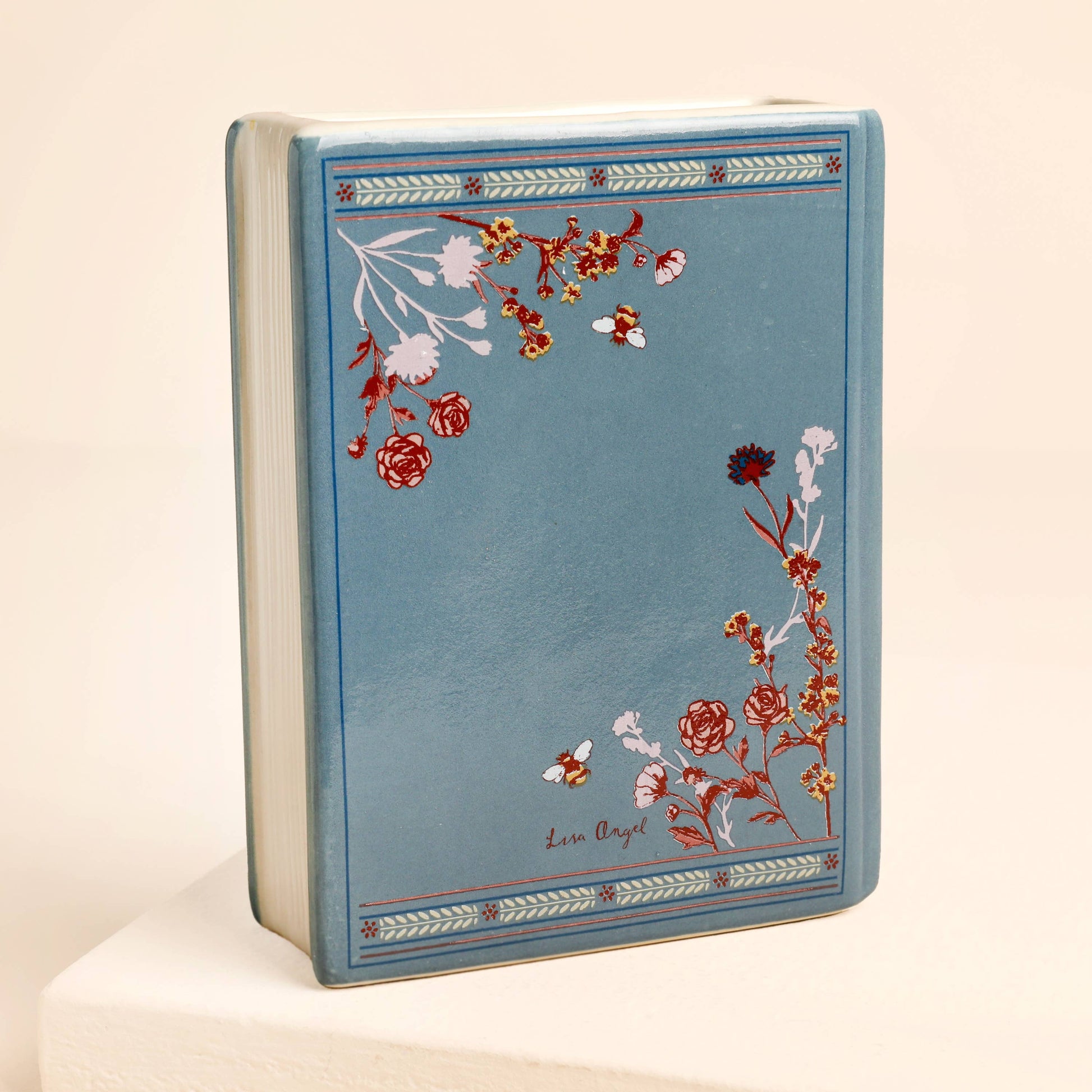Back of Once Upon A Time ceramic book vase with floral pattern.