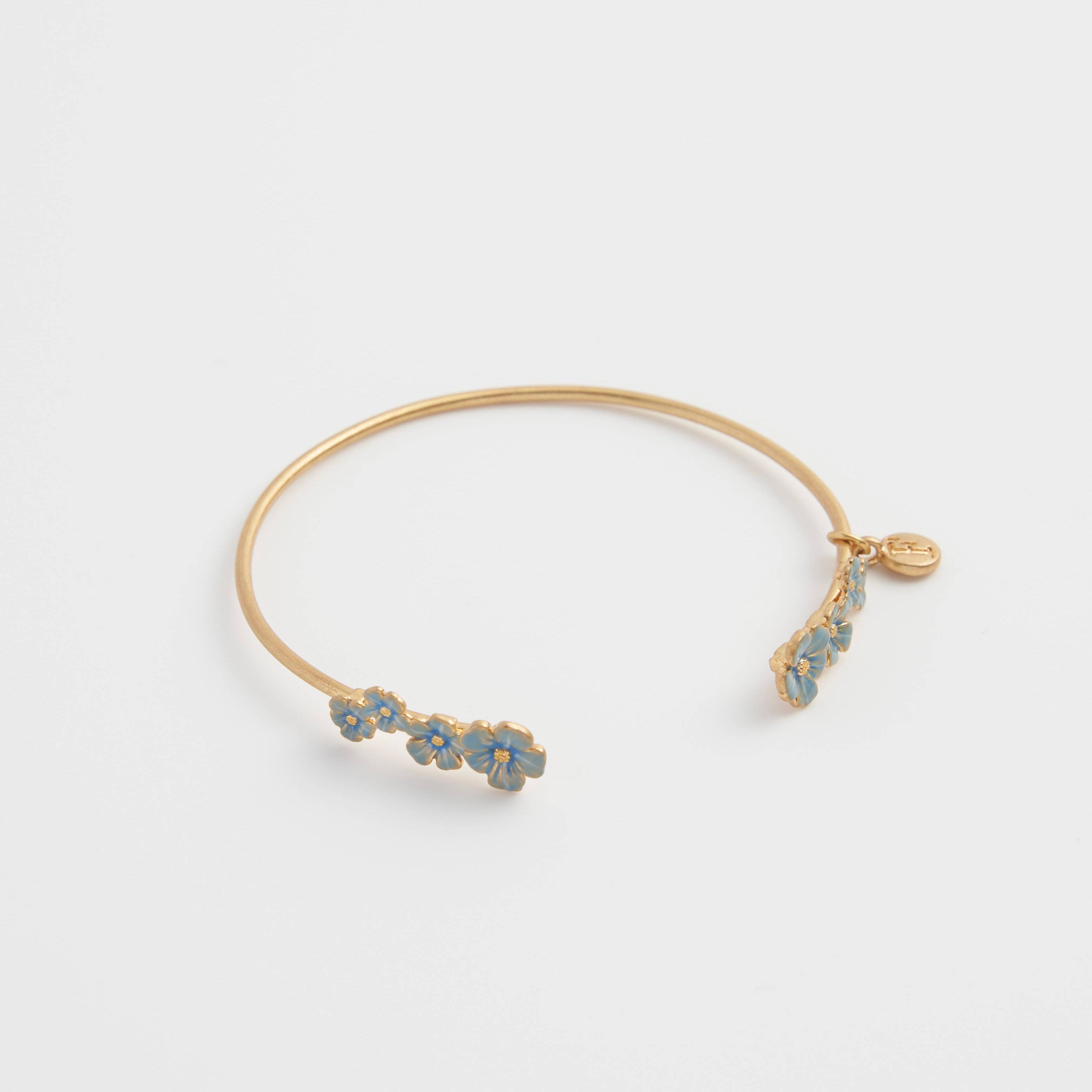 Open gold-plated forget-me-not bangle with blue enamel floral detailing
