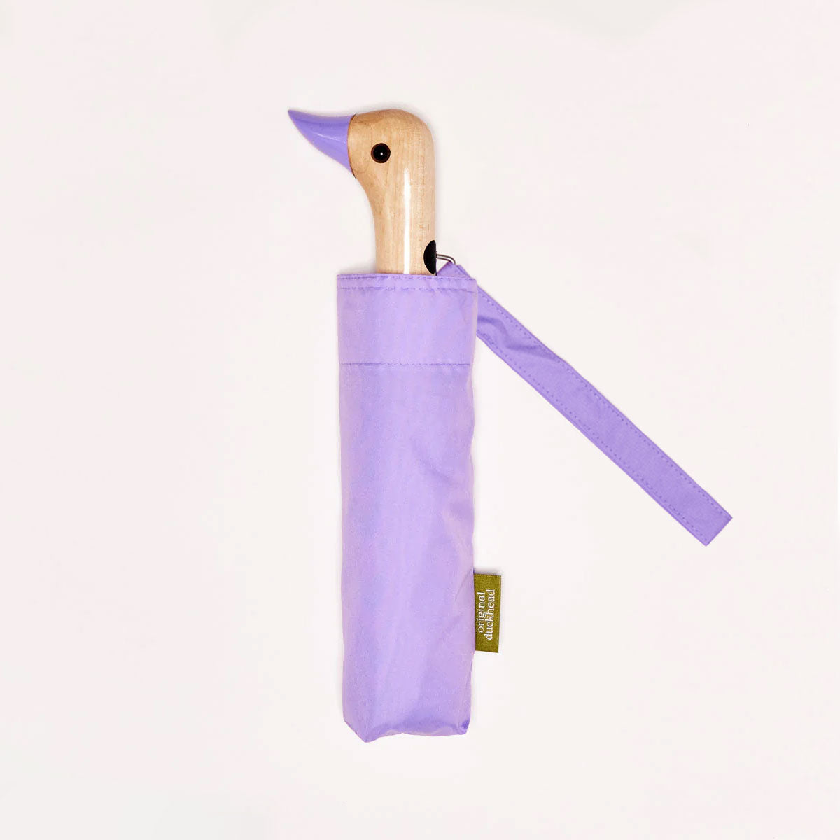 Closed lilac duck umbrella flat lay showing wooden duck head handle
