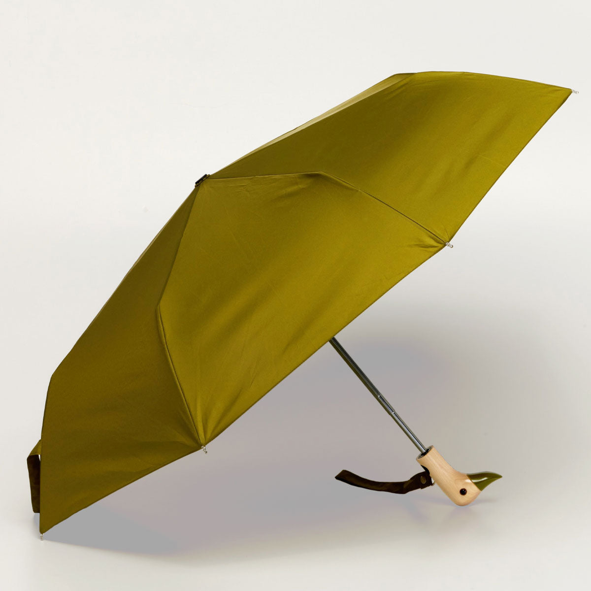Olive compact duck umbrella open side view on light background