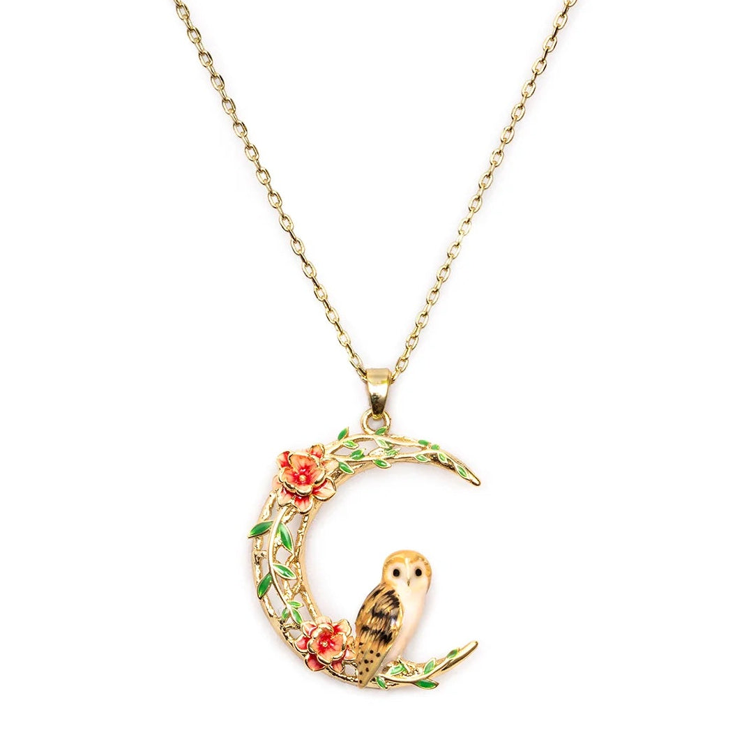Owl in a Moon Pendant by Bill Skinner featuring a hand-painted barn owl on a gold crescent moon with enamel flowers on white background.