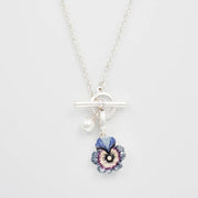 Silver toggle necklace with pansy and pearl charms close-up