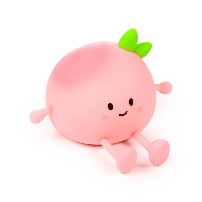 Pink silicone Peach Sleep Lamp switched off on white background.