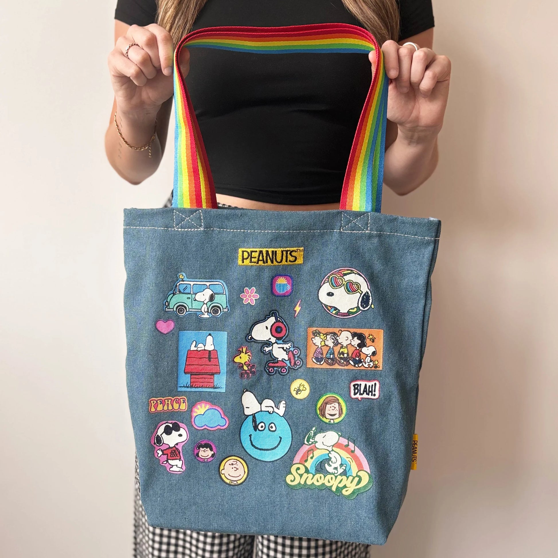 Close-up of rainbow straps on Peanuts denim tote bag