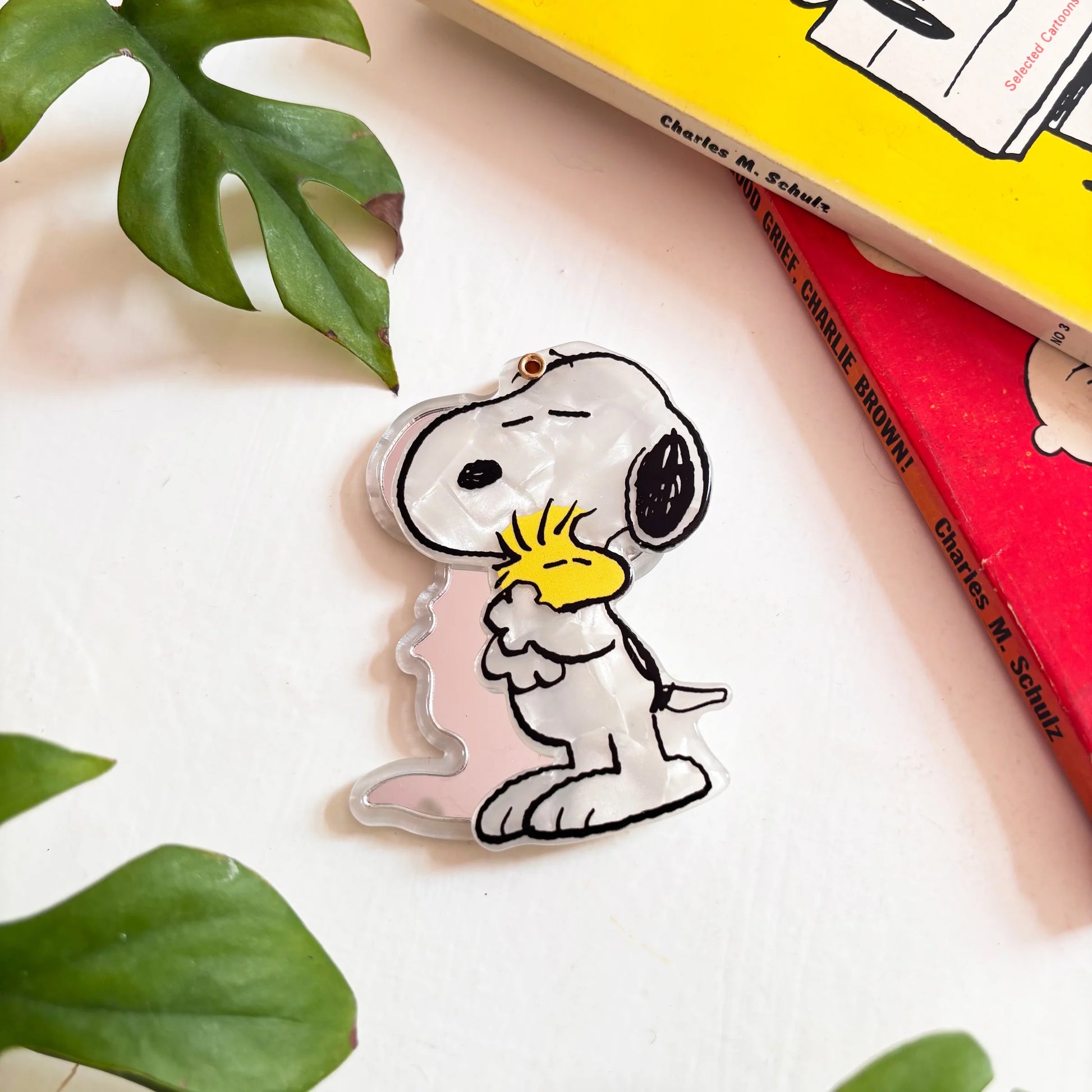 Angled view of Snoopy and Woodstock Peanuts compact mirror with books
