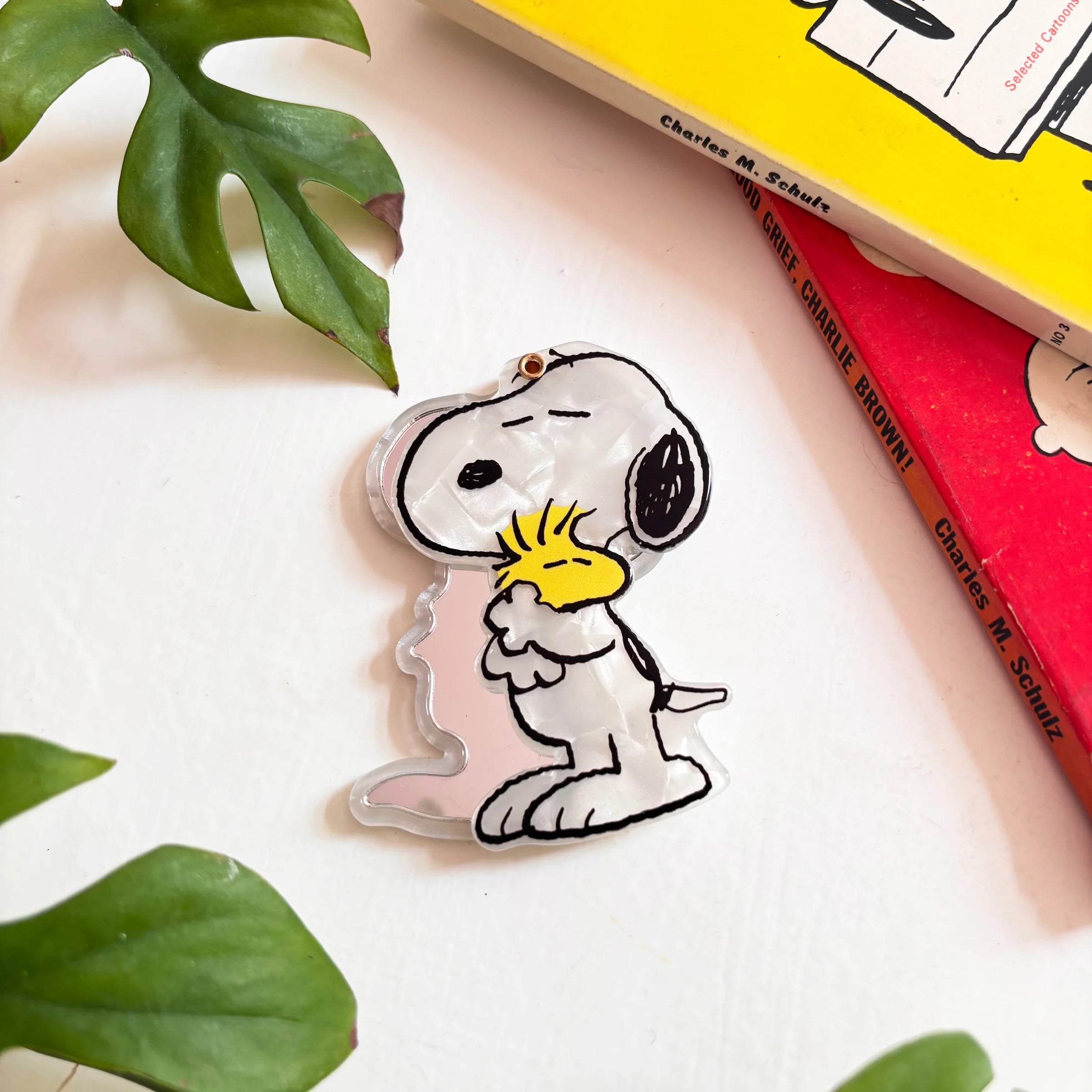 Angled view of Snoopy and Woodstock Peanuts compact mirror with books