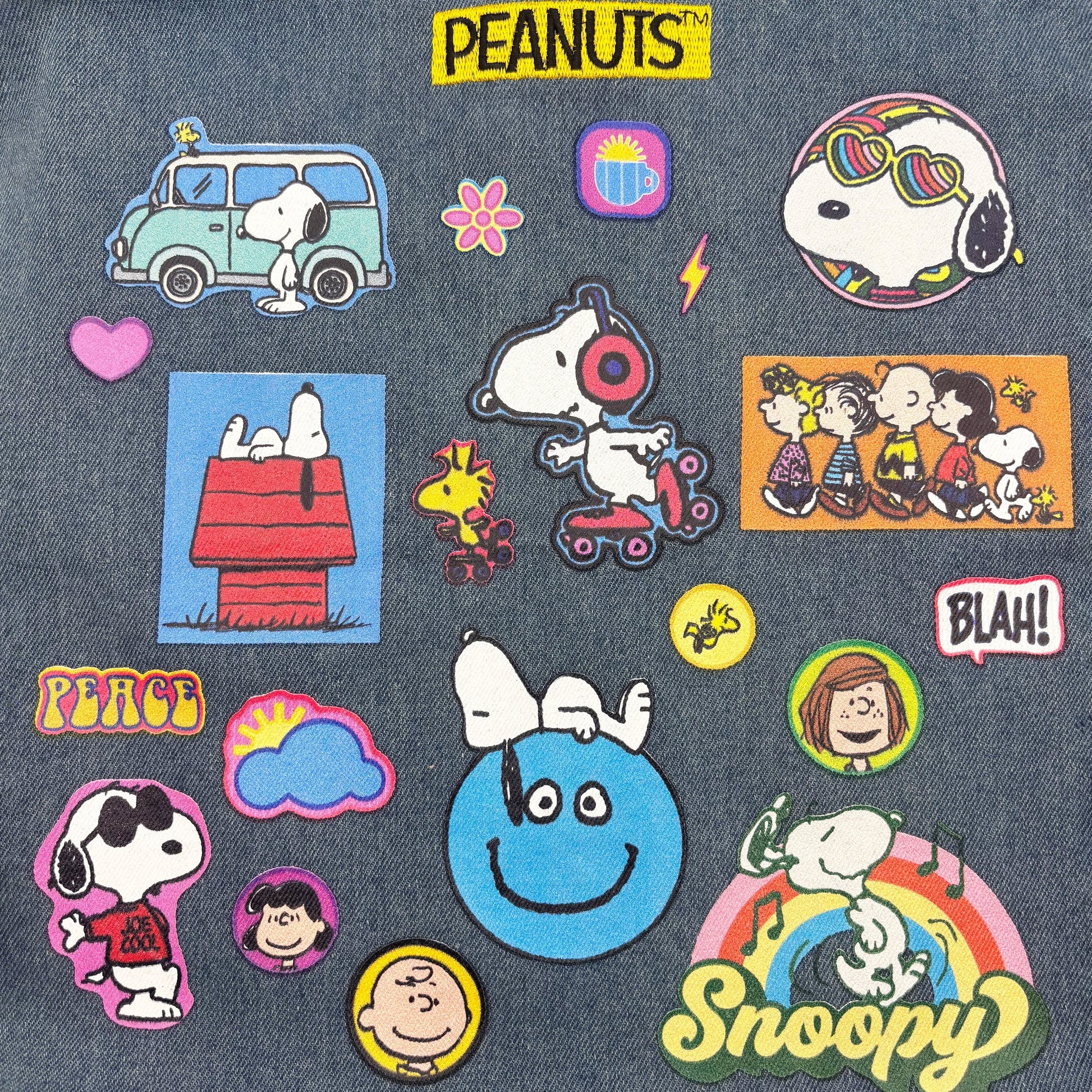 Close-up of Snoopy and Peanuts patches on denim tote bag