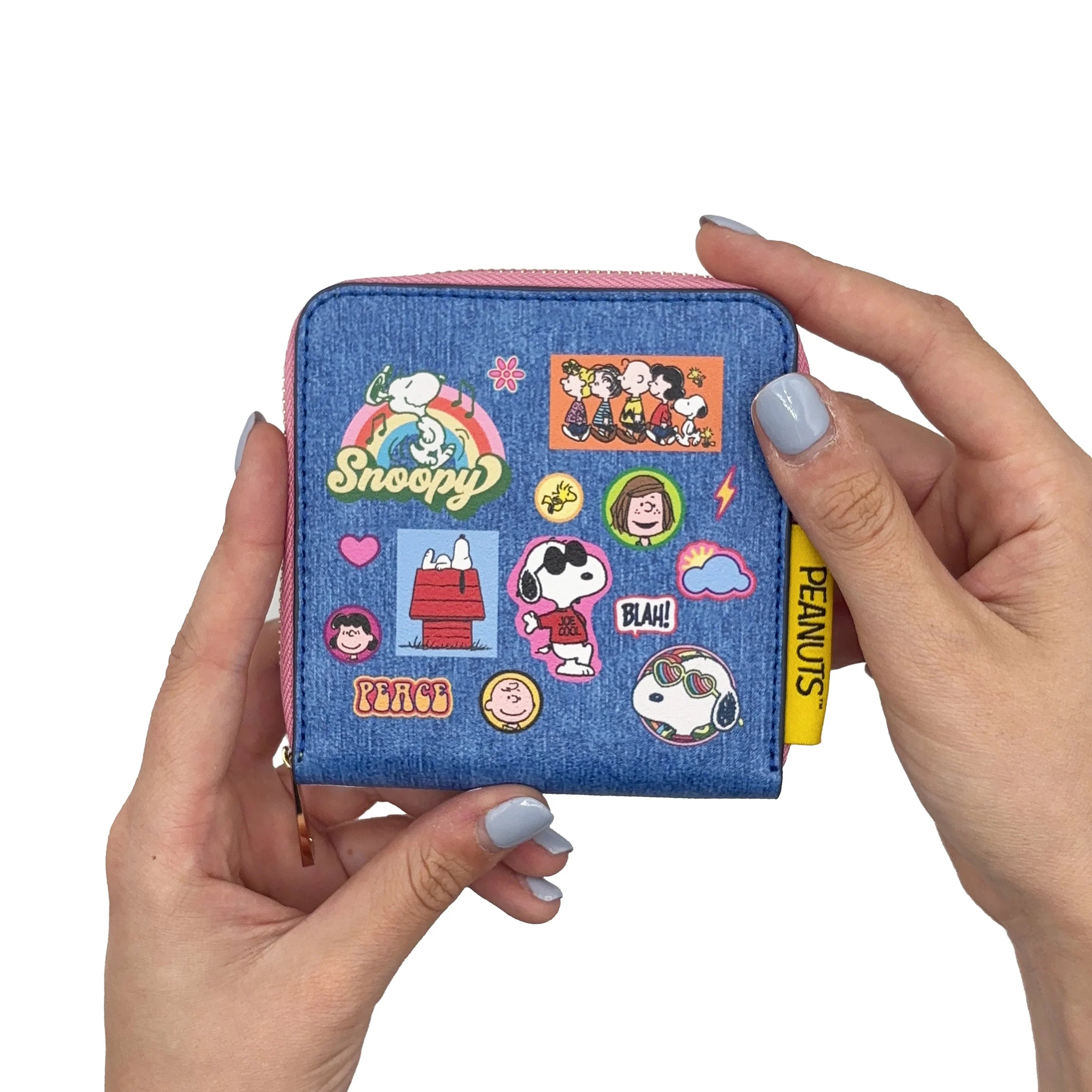 Peanuts zip purse held in hands showing compact size