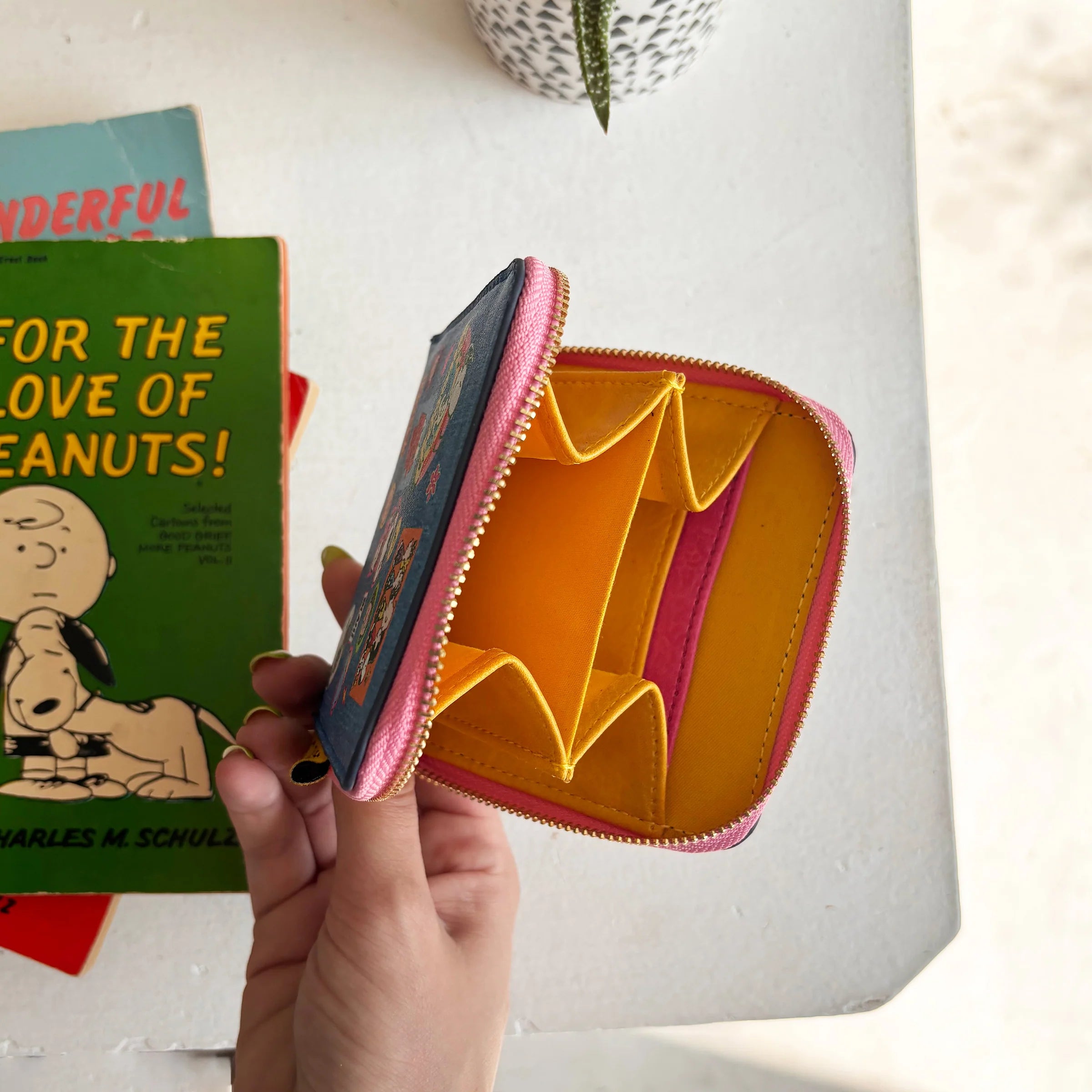 Inside of Peanuts zip purse showing card slots and compartments