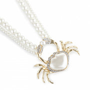 Close-up of Bill Skinner Pearly Crab Necklace showing pearlised crab pendant with gold-plated claws and crystal detailing.