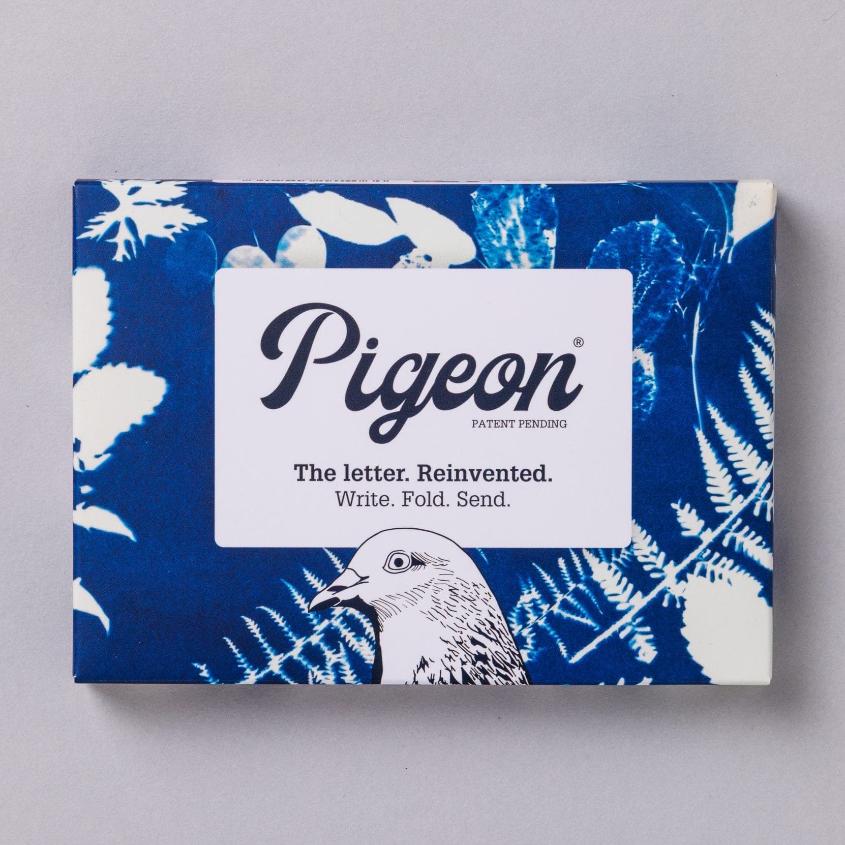 Apothecary Pigeons pack front with blue cyanotype botanical design on grey background